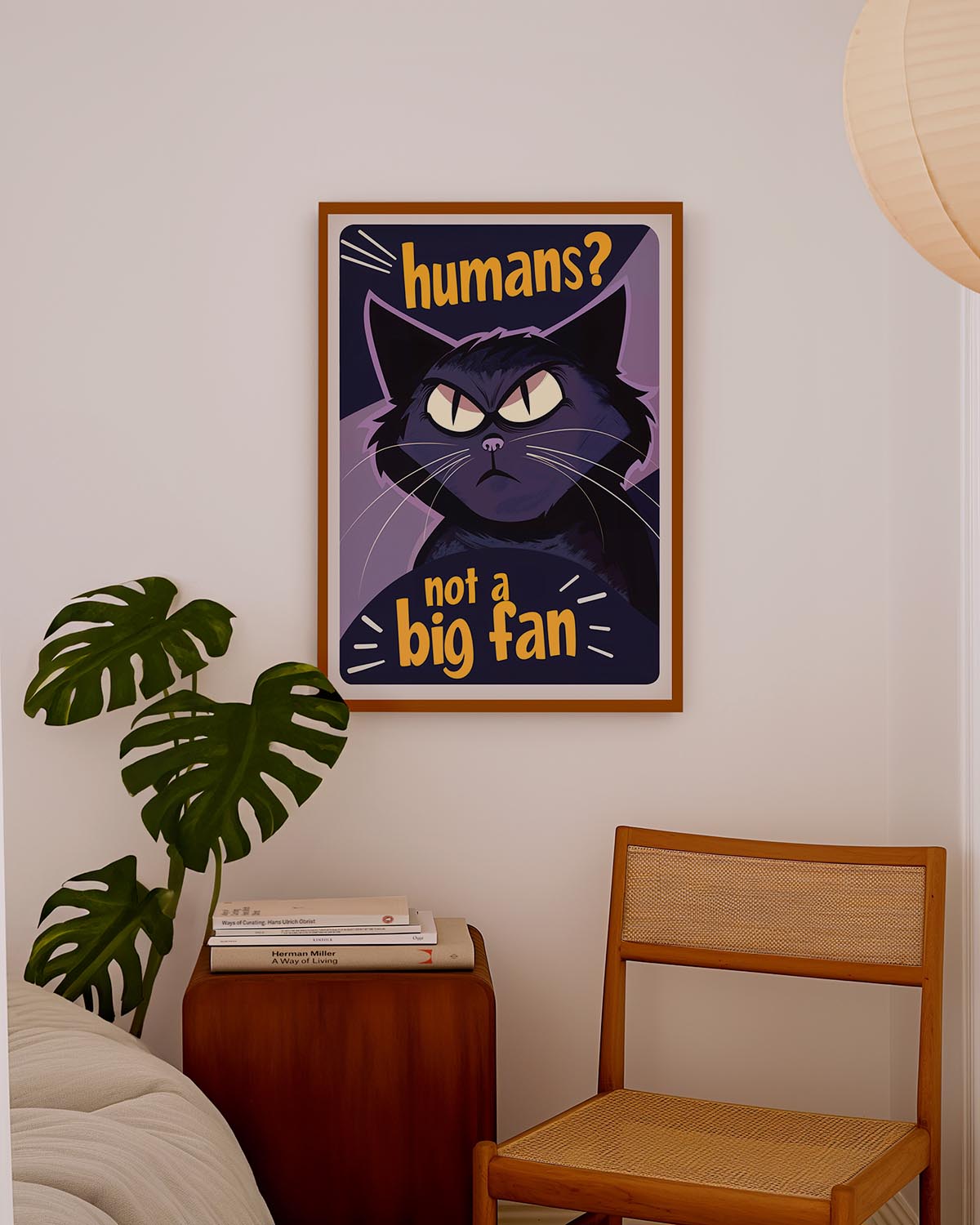 Poster of a grumpy black cat with yellow eyes and the text "Humans? Not a big fan" in bold orange letters against a dark purple background.